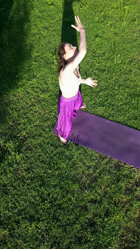 Drone Pulling Away from Woman Practicing Yoga in a Rural Garden Stock-Footage 345125617