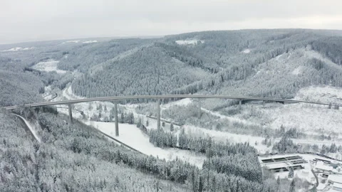 Drone pulling back and rising over highway bridge with cars and train below in s Stock Footage 332012389