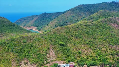Drone pulling back from mountain peak to colorful homestays in Nam Du 4K Stock Footage 333938964
