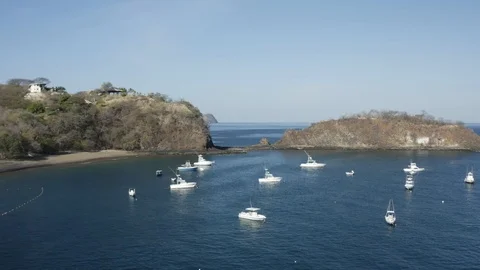 Drone pulling back over yachts in tropical cove Stock Footage 103340149