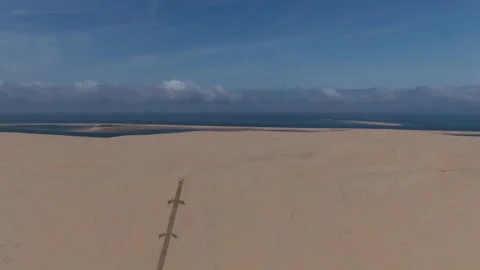 Drone pulling back revealing camping foreground at Dune du Pilat, France Видео 333108064