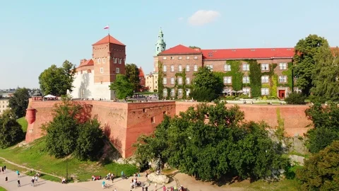 Drone pulling out over Vistula River, Wawel Royal Castle, Krakow Old Town Poland Stock Footage 99323511