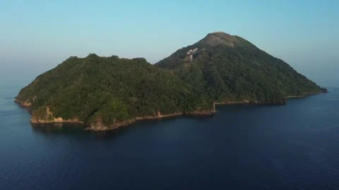 Drone pulls back from forested island Stock-Footage 327465240