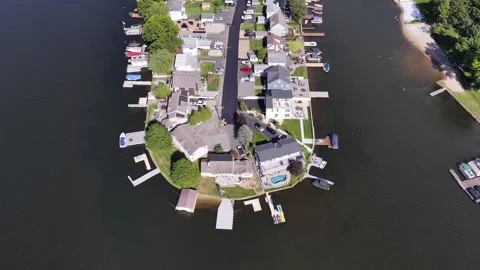 Drone pulls back from Lake Hopatcong peninsula homes and docks Stock Footage 346882395