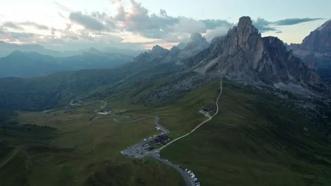 Drone pulls back over Passo di Giau at sunrise, La Gusela peak Stock Footage 346288173