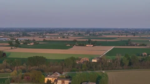 Drone pulls back over Pianura Padana agricultural fields and tree lined parcels Stock Footage 334719414