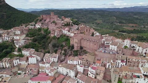 Drone pulls back over Vilafames village and Iglesia de la Asuncion Stock Footage 346062432