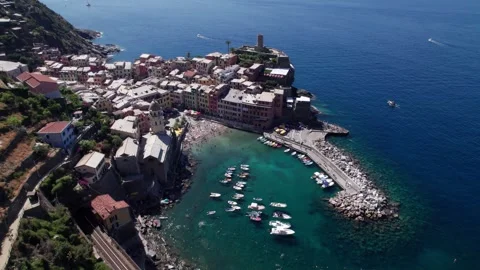 Drone pulls back from Vernazza harbour and beach, Cinque Terre Video stock 346288789