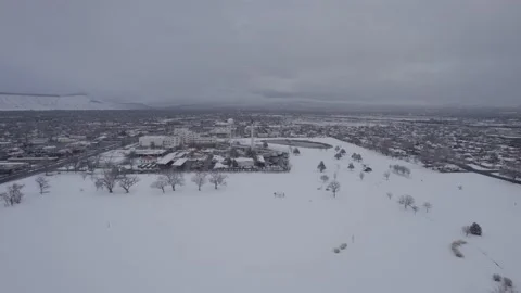 Drone Pulls Back From Veteran Hospital Over Snowy Public Golf Course Stock Footage