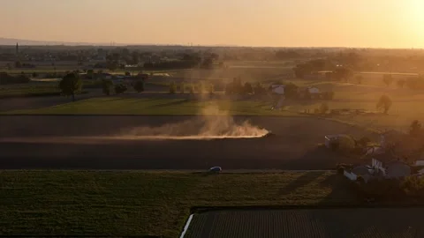 Drone push in above spring field cultivation and dust plume in the Po Valley Stock Footage 335968436