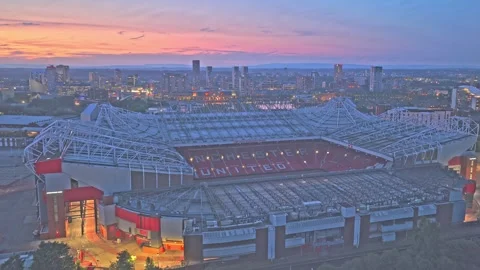 Drone push-in flyover revealing Old Trafford and Manchester skyline at blue hour Stockbeeldmateriaal 341184595