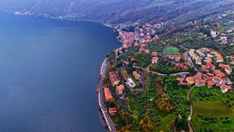 Drone Push Forward Over Lakeside Village and Olive Groves on Lake Iseo Italy Видео 336709141