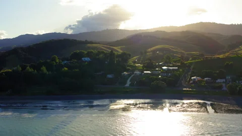Drone Push In On Homes Along New Zealand's Coromandel Bay 4K 30FPS Stock Footage 234475620