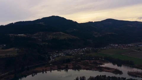 Drone push out over river valley village Stock Footage 330227020