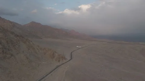 Drone Push In Over Ladakh Road with Cars at Golden Sunset Mountain View Over Stock Footage 335746555
