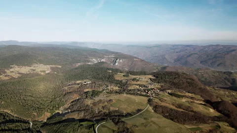 Drone push-in over Tara Mountain valley with rural village and forest, Serbia Stock Footage 328226399