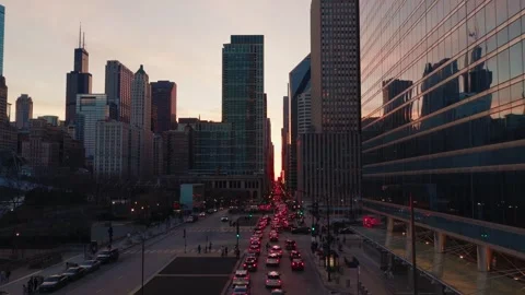 Drone push-reveal through Chicago Loop canyon toward Chicagohenge sunset 動画素材 337410627