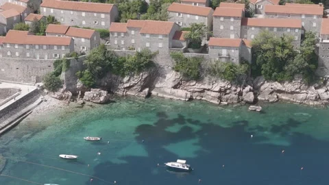 Drone Push from Shoreline Boats Toward Sveti Stefan – Montenegro Stock Footage 310335403