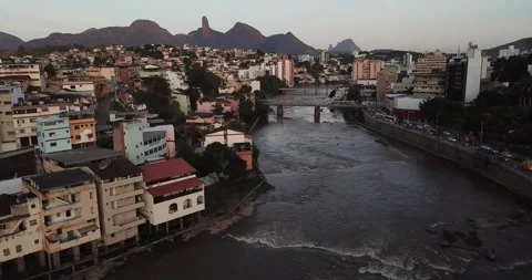 Drone push-in shot of Cachoeiro do Itapemirim city and Itapemirim River, ES Stock Footage 317734562