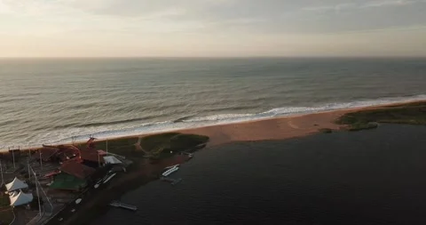 Drone push-in shot of Macaé cityscape with ocean and Imboassica Lagoon Stock Footage 317731130