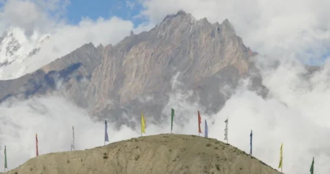 Drone push in shot of prayer flags and sandy ridge in Mustang Nepal Stock Footage 336339859