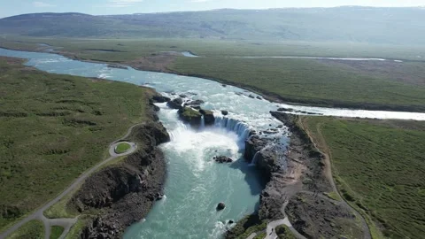 Drone push in toward Godafoss waterfall and turquoise river canyon, Iceland Stock Footage 346551982