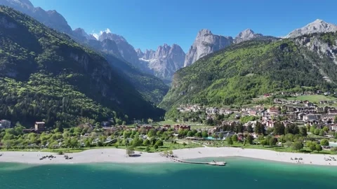 Drone Push-In Toward Towering Dolomite Peaks and Alpine Resort Village Stock Footage 337159948