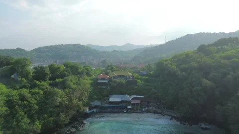 Drone Push-in from Tropical Bay to Hidden Harbor with Boats Bali Stockbeeldmateriaal 312485447