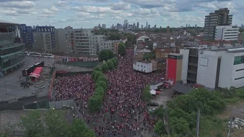 Drone pushes over railway towards crowd celebrating at the Emirates Stadium [4K] Stock Footage 336391507