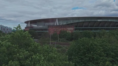 Drone pushes through trees towards revealing the Emirates Stadium [4K] Stock Footage 336391617