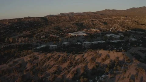 Drone pushing in toward small New Mexican town Stock Footage 167672311
