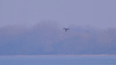 Drone quad copter with high resolution digital camera above the water surface Video stock 104353585