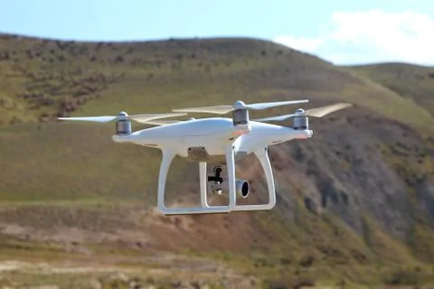 Drone quad copter with high resolution digital camera on the sky .White drone Stock Photos