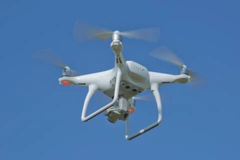 Drone quad copter with high resolution digital camera on the sky . White dron Stock Photos