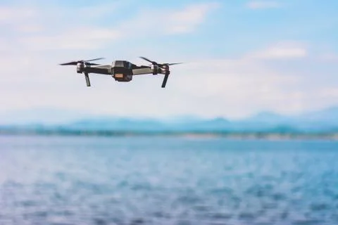 Drone quad copter  with high resolution digital camera flying the sky with la Stock Photos