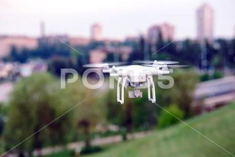 Drone quad copter with high resolution digital camera flying hovering over the Stock Photos