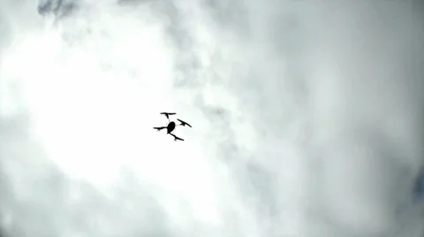 Drone Quad-Copter Swoops Overhead and Up Against Cloudy Sky 4 Stock Footage 33862693
