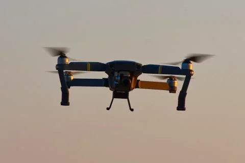 Drone quad copters with high resolution digital camera flying aerial over sun Stock-Fotos