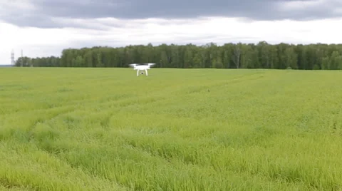 Drone quadcopter with camera flying on a clear sunny sky sunset background Stock Footage 64078009