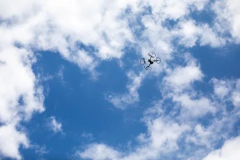 Drone quadcopter with digital camera on blue sky background Stock Photos