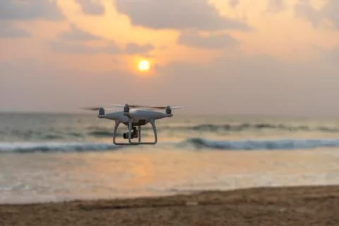 Drone quadcopter with digital camera flying to take photo and video on ground an Stock Photos