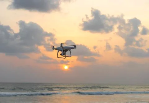 Drone quadcopter with digital camera flying to take photo and video on ground an Stock Photos