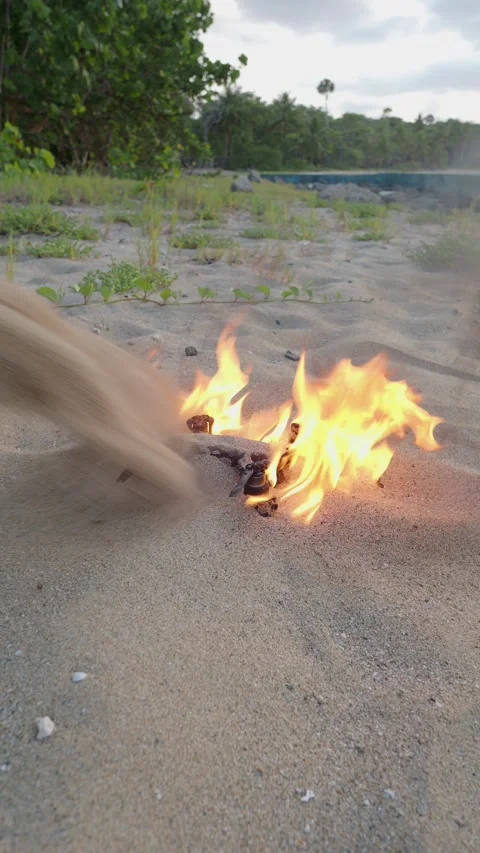 Drone Quadcopter is on fire, the flame is extinguished by sand on the beach. Stock Footage 277515922