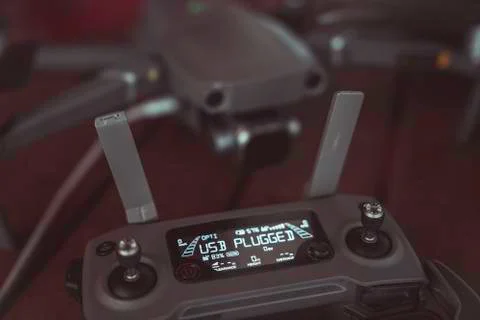 Drone quadcopter with a flight controller and notebook on the old wooden table. Stock Photos