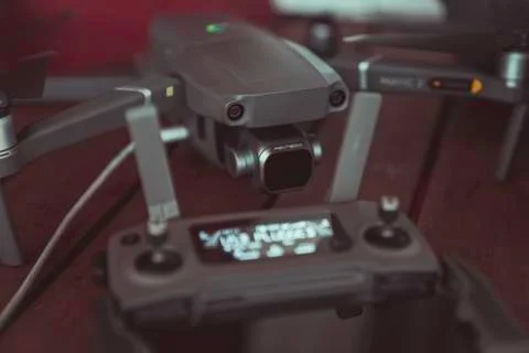 Drone quadcopter with a flight controller and notebook on the old wooden table. Stock-Fotos