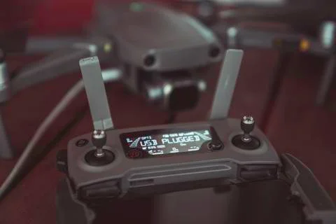 Drone quadcopter with a flight controller and notebook on the old wooden table. Stock-Fotos