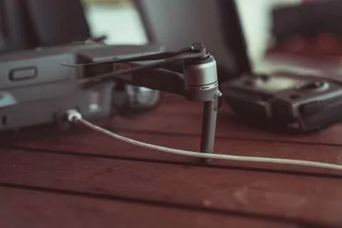 Drone quadcopter with a flight controller and notebook on the old wooden table. Stock-Fotos