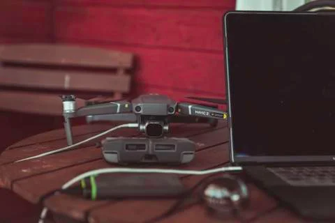 Drone quadcopter with a flight controller and notebook on the old wooden table. Stock-Fotos
