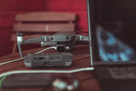 Drone quadcopter with a flight controller and notebook on the old wooden table. Stock-Fotos