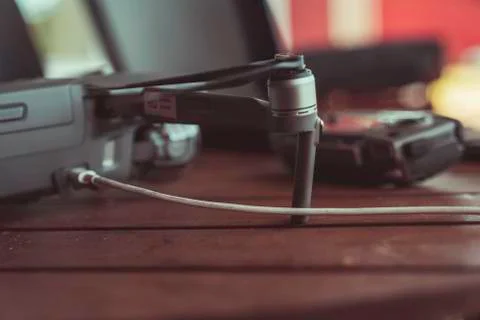 Drone quadcopter with a flight controller and notebook on the old wooden table. Stock-Fotos